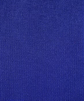 Detailed close-up of blue textile fabric showcasing its texture and stitching.