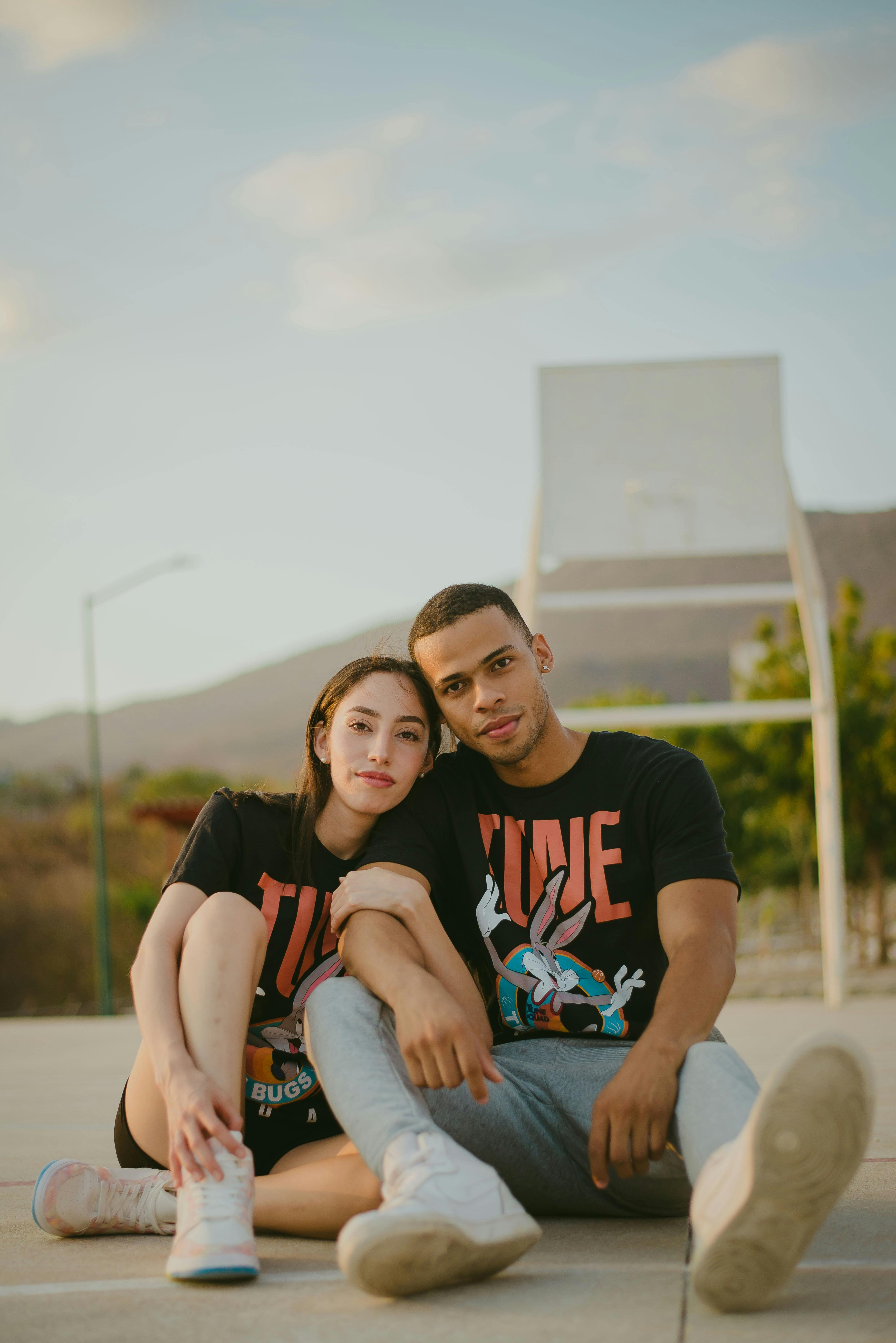 couple sitting on a basketball court