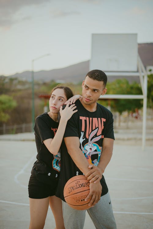 Free Man and Woman Holding Basketball Stock Photo