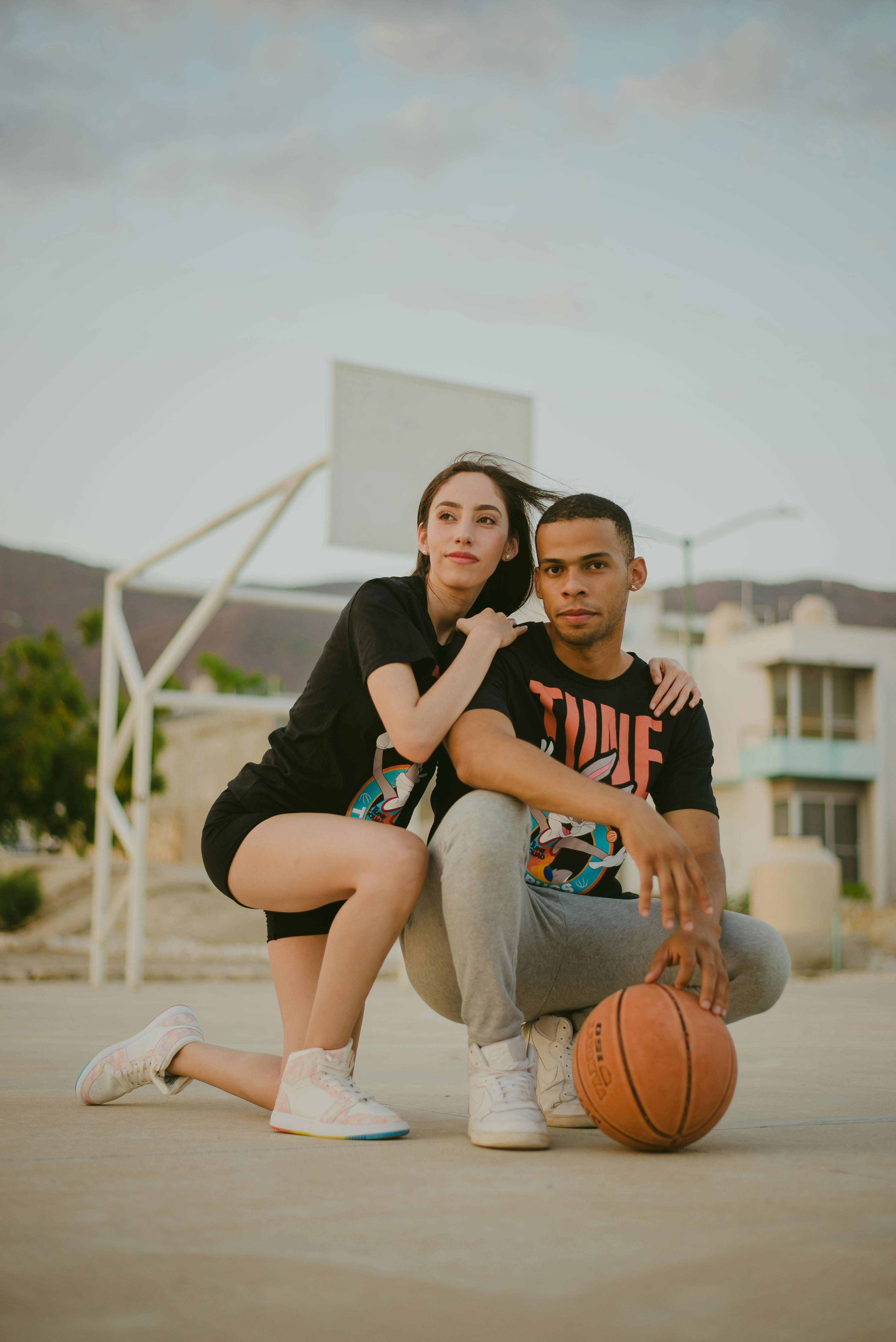 Sports and basketball. A young teenager in a blue tracksuit poses with a  basketball in his hands and looks away. In the background, a basketball  court Stock Photo - Alamy