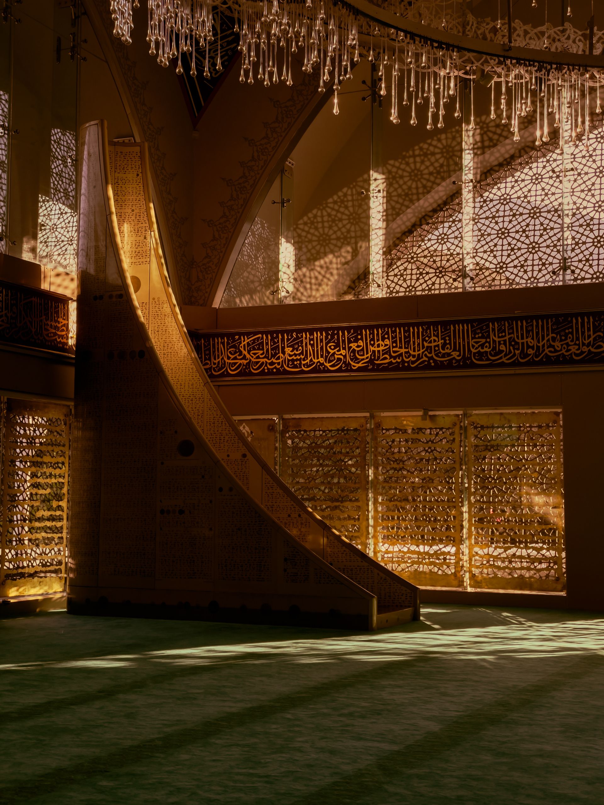 Sunlight illuminating the intricate interior design of a traditional mosque with ornate patterns