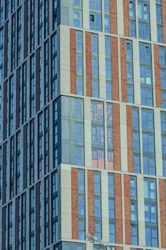 Close-up of modern skyscraper facade showing windows and structural detail.