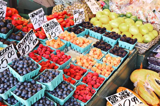Vibrant array of fresh berries and citrus at a lively local market stall.