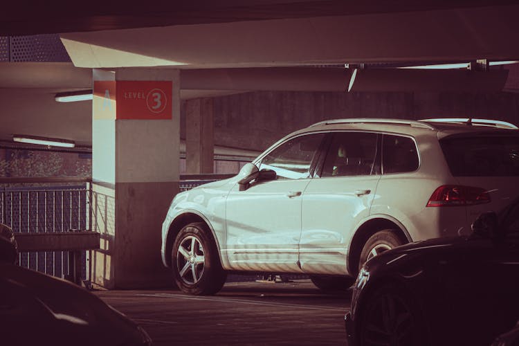 White Car Parked On Parking Lot 