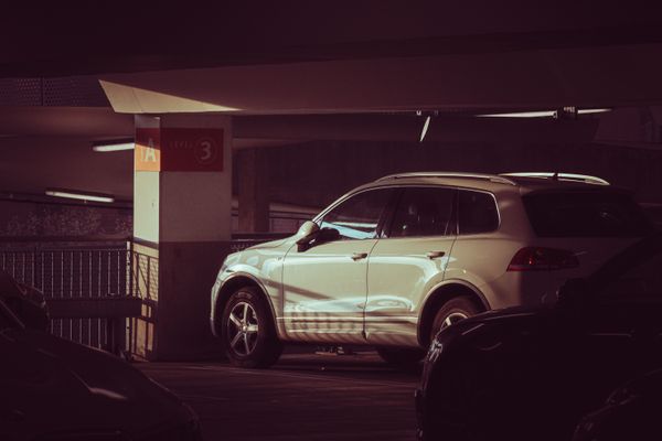 Pale green SUV parked on an upper level of a covered car park. Photo by Boys in Bristol Photography on Pexels