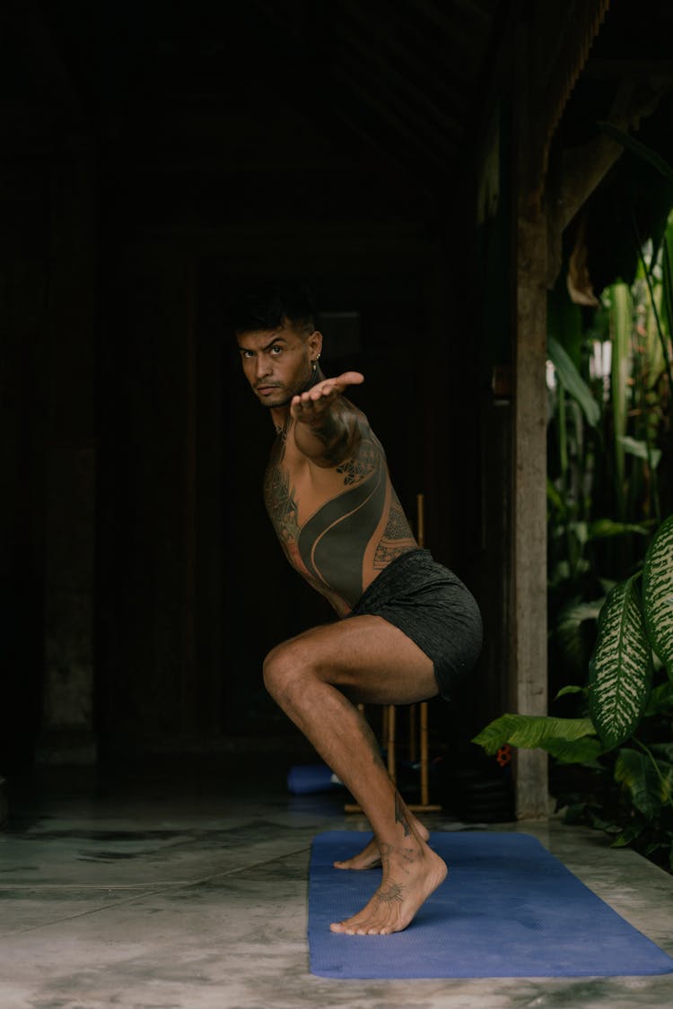 Tattooed Man Practising Yoga 