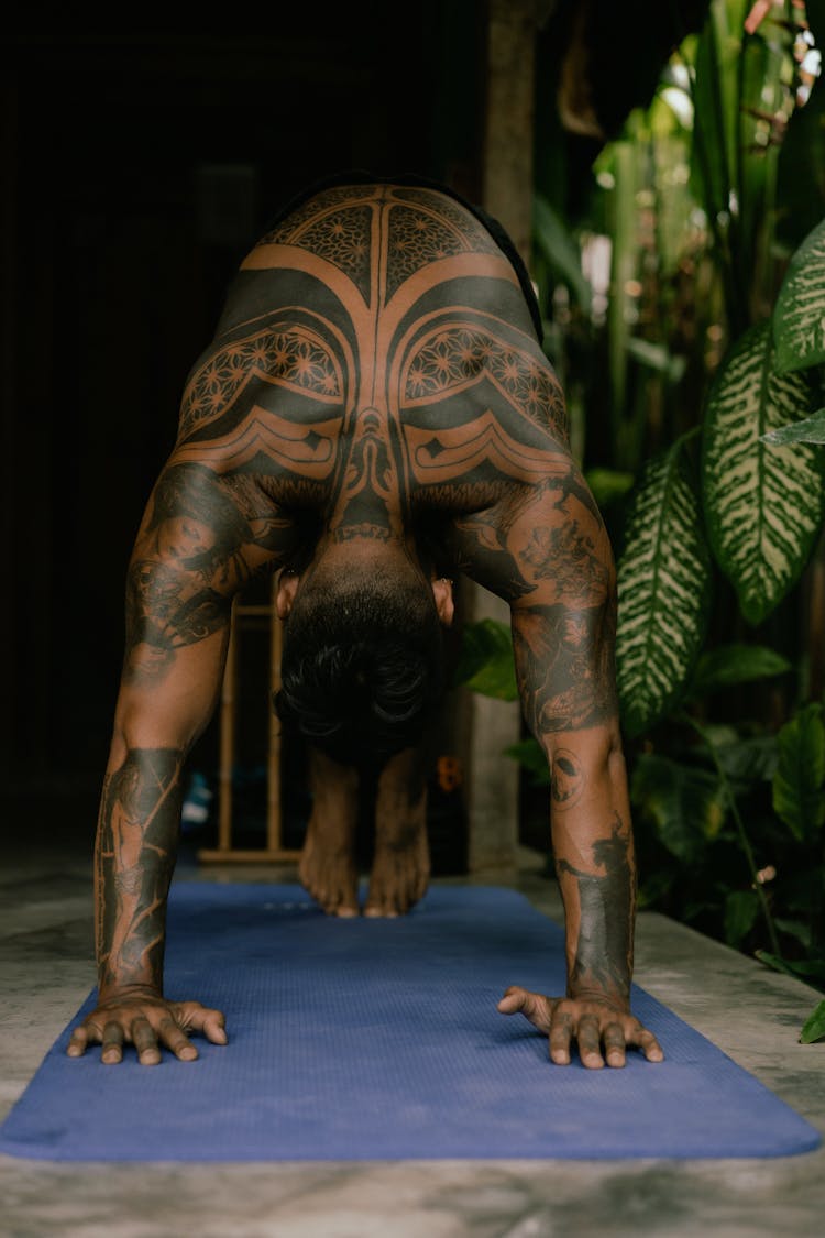 Tattooed Man Practising Yoga 