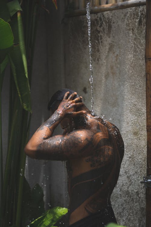 Man with Tattoos Washing Body