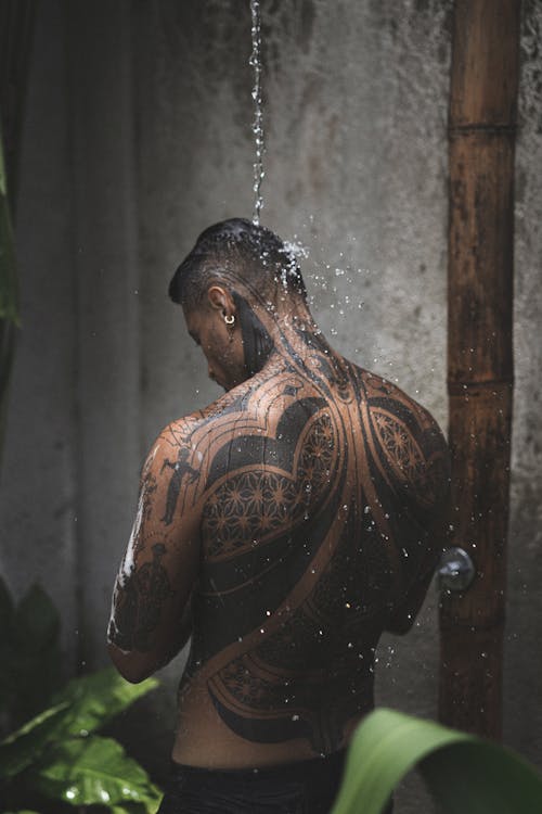 Man with Tattoos Topless under Water