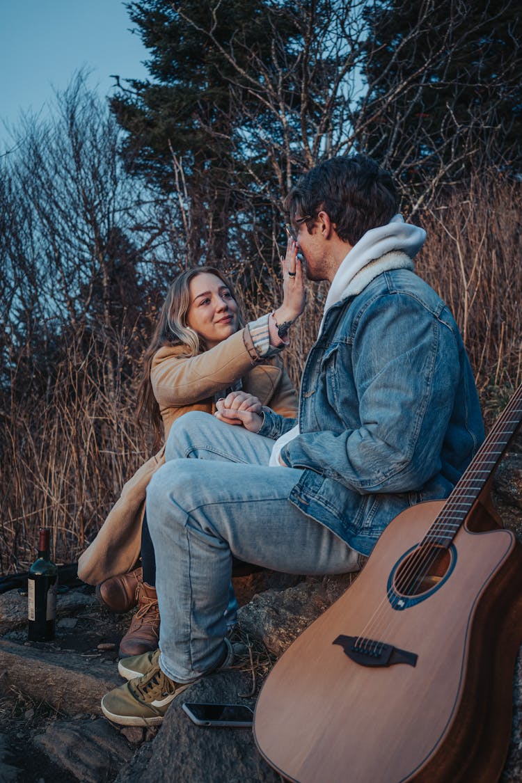 Couple Relaxing Together In Mountains