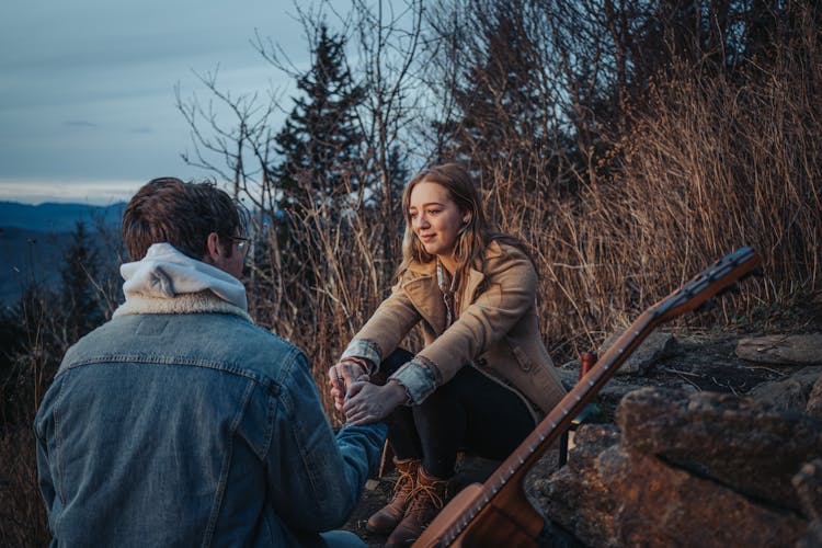 Couple Relaxing Together In Mountains