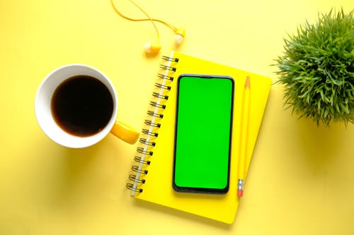 Smartphone on Yellow Notebook