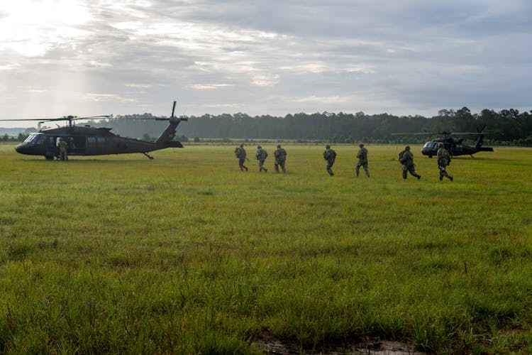 Soldiers Walking On The Grass Field