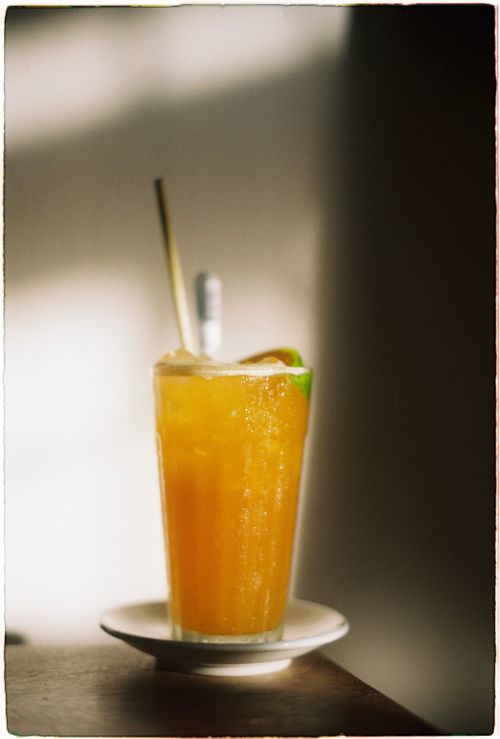 Free Close-up of an orange juice cocktail with ice and lime on a table. Stock Photo
