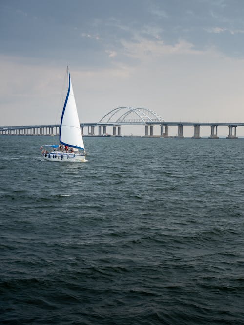 Sailboat on Sea, Bridge in Background