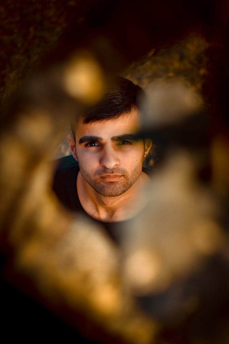 View On Handsome Young Man Through Hole