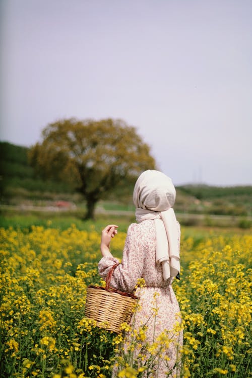 Woman on Meadow among Flowers