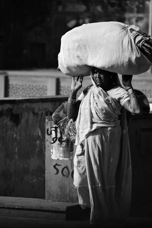 Monochrome Photo of a Woman with a Bag on Her Head