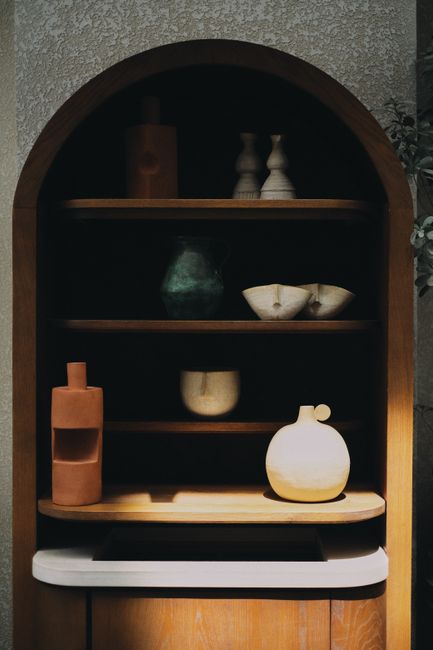 Elegant wooden shelf with boho ceramic decor in Dubai home.