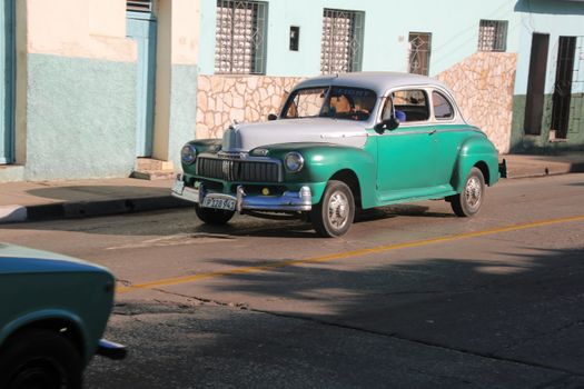 Green Vintage Car Parked on Sidewalk