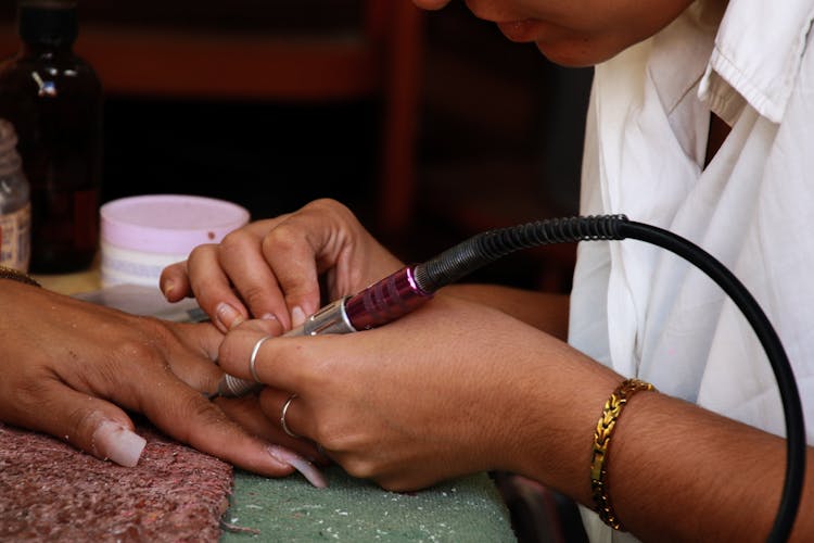 Close-up Of Woman Getting Tattoo On Finger