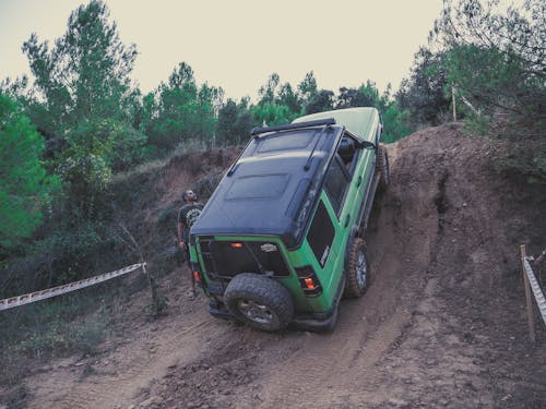 Off-road Car Driving Up a Muddy Hill 