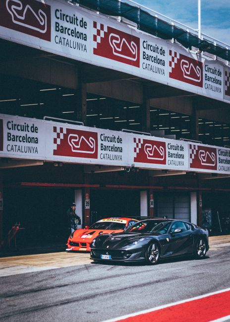 Sports cars parked at Circuit de Barcelona Catalunya, showcasing a thrilling motorsport atmosphere.