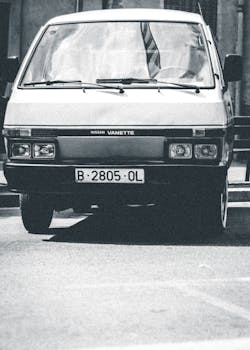 Classic Nissan Vanette captured in monochrome, reflecting vintage automotive style.