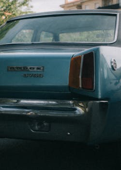 Close-up of a vintage Dodge Dart 3700 GT in blue, showcasing its classic design and style.