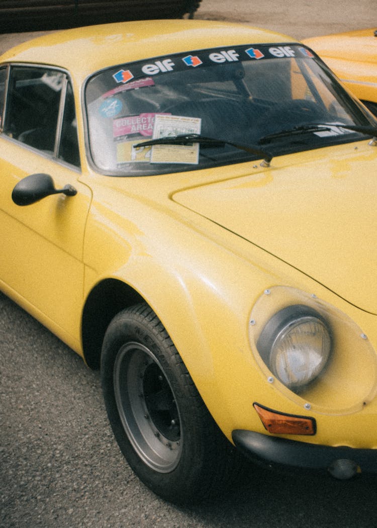 Yellow Vintage Car With Racing Stickers