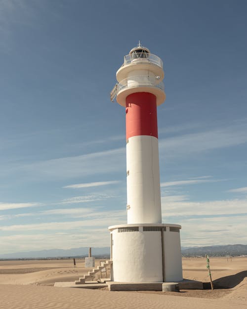 Free White and Red Lighthouse Under Blue Sky Stock Photo