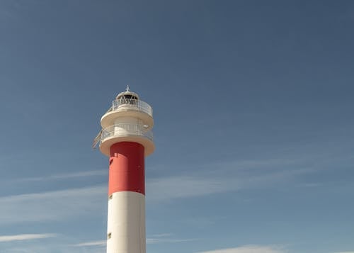 Free Red and White Tower Under Blue Sky Stock Photo