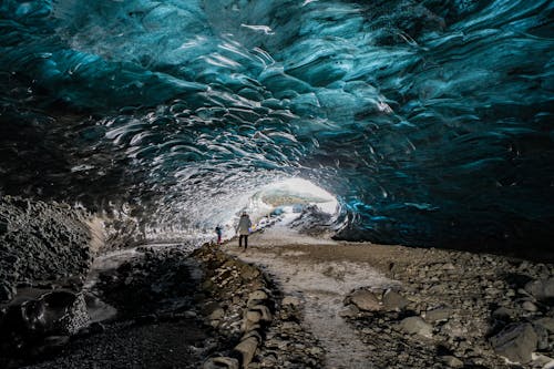 Hikers in an Ice Cave Interior 