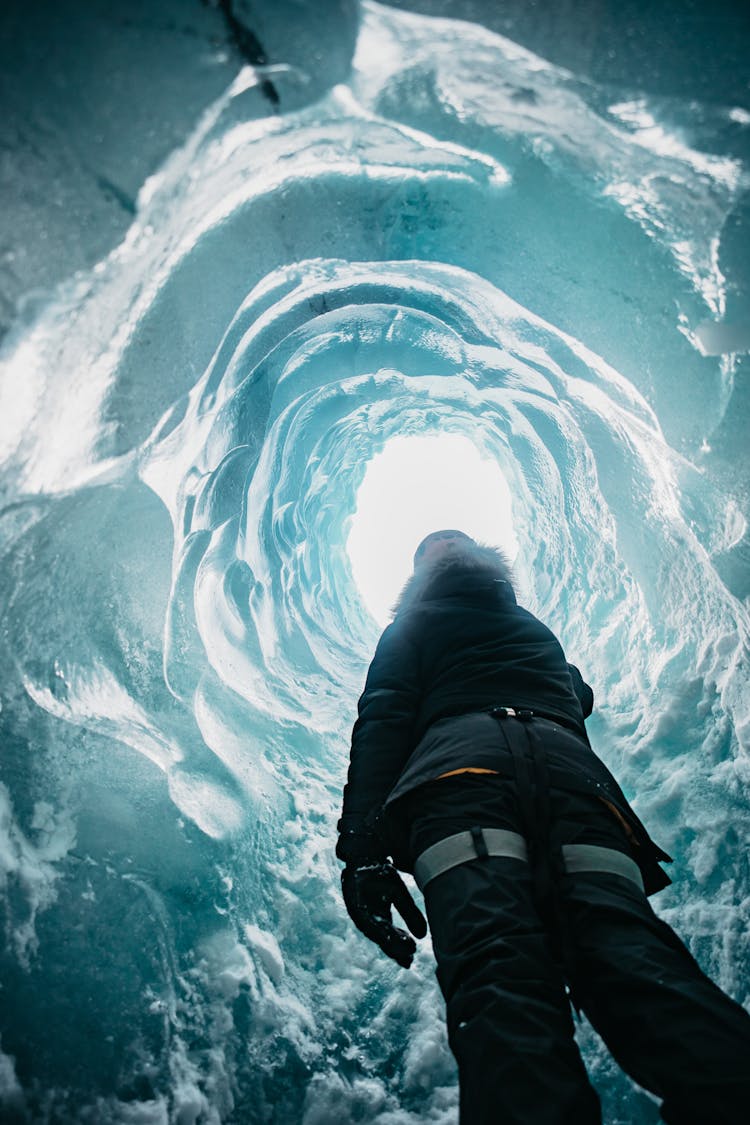 A Person Looking Up At A Hole On The Surface