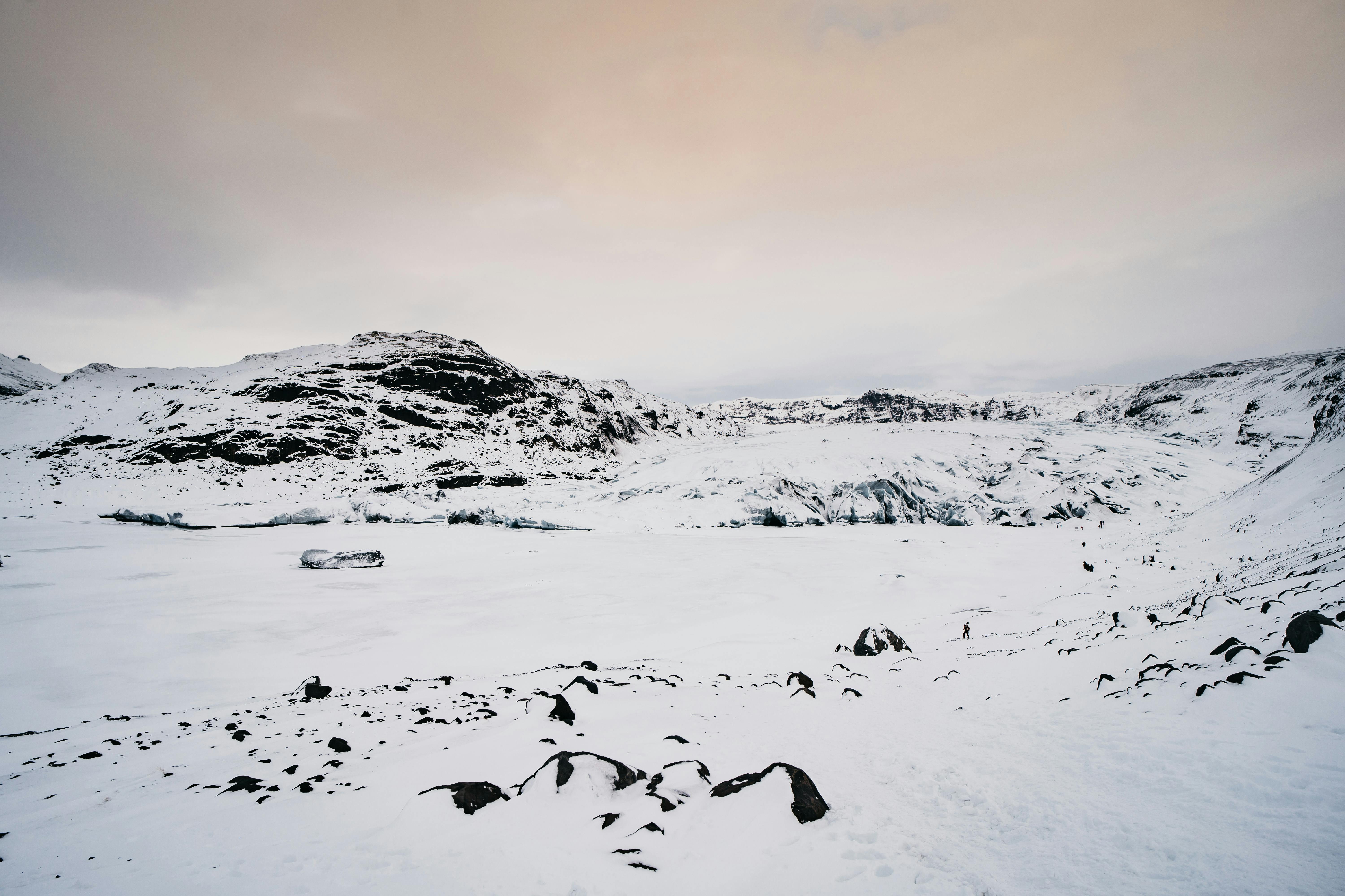 Stunning winter landscape in Iceland showcasing snow-covered mountains and a serene sky.