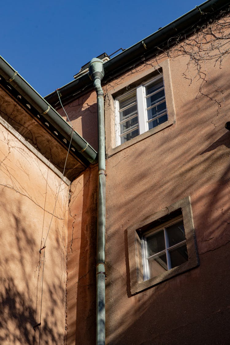 A Pipe Near Building Windows