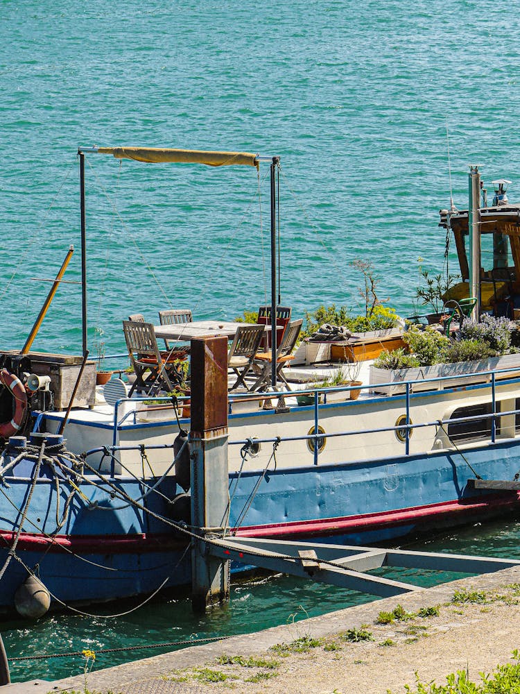 Fisherman Boat On Rope In Water