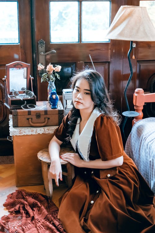 A Woman in Brown and White Dress