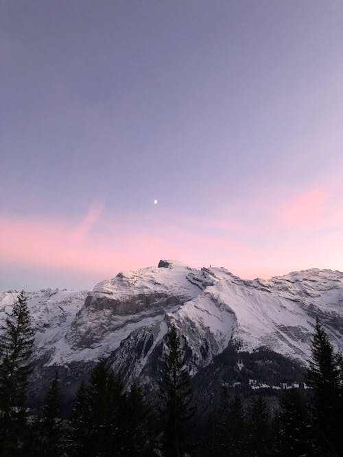 Free Scenic View of a Snow Covered Mountains during Sunset Stock Photo