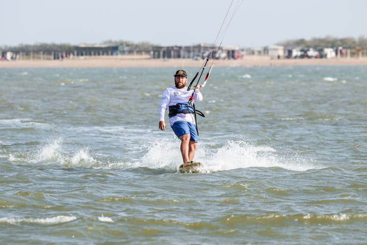 Man Windsurfing On The Sea