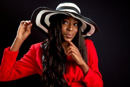 Woman Holding White and Black Hat