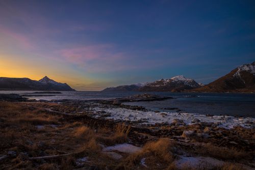 Free Breathtaking winter sunset over a rocky coastal landscape in Nordland, Norway. Stock Photo