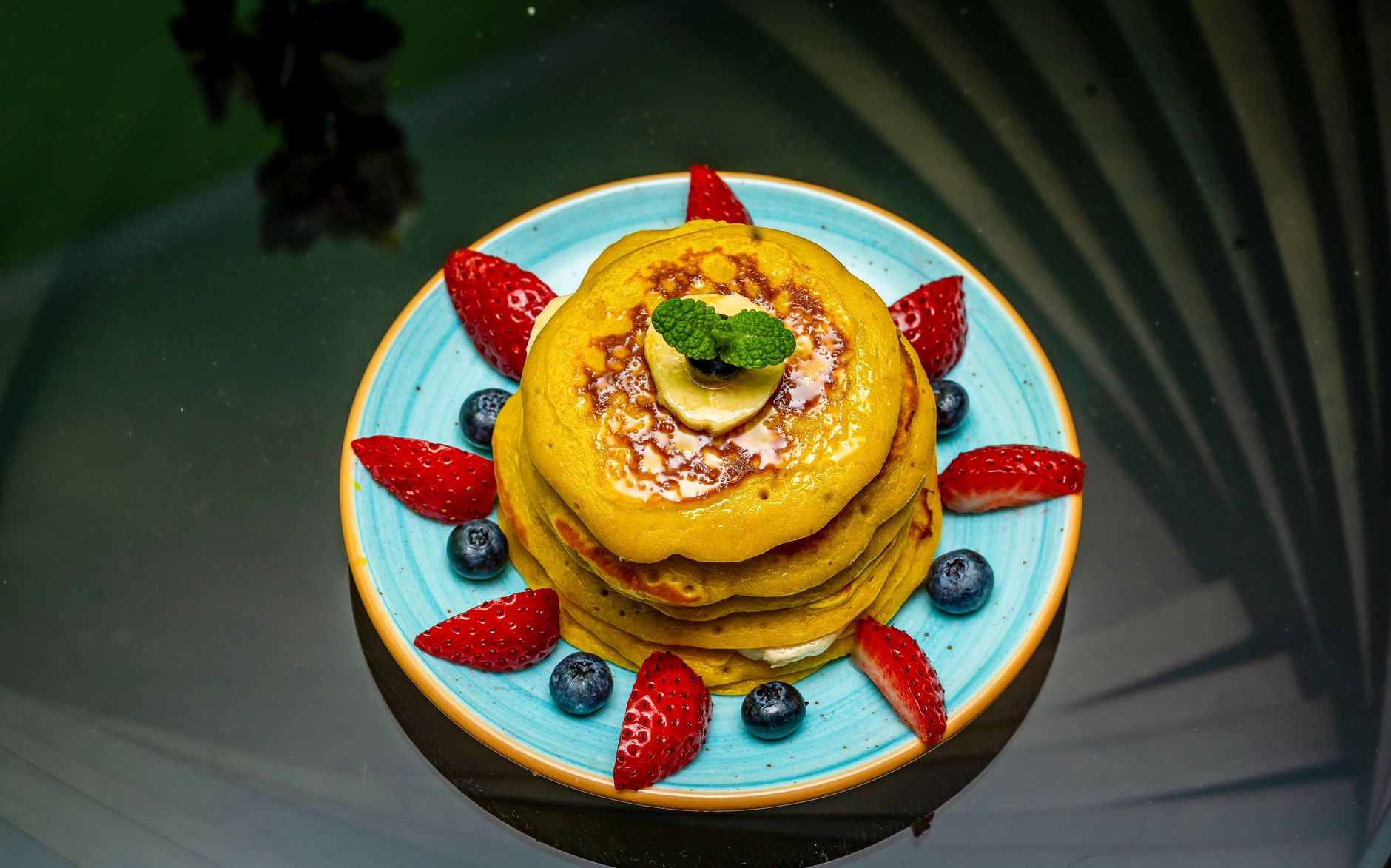 Golden blue corn pancakes sizzling on griddle