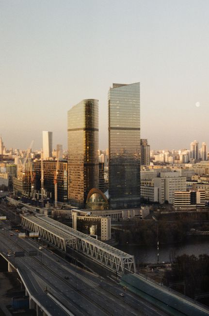 Aerial cityscape of Moscow with modern skyscrapers and urban structures at sunset.