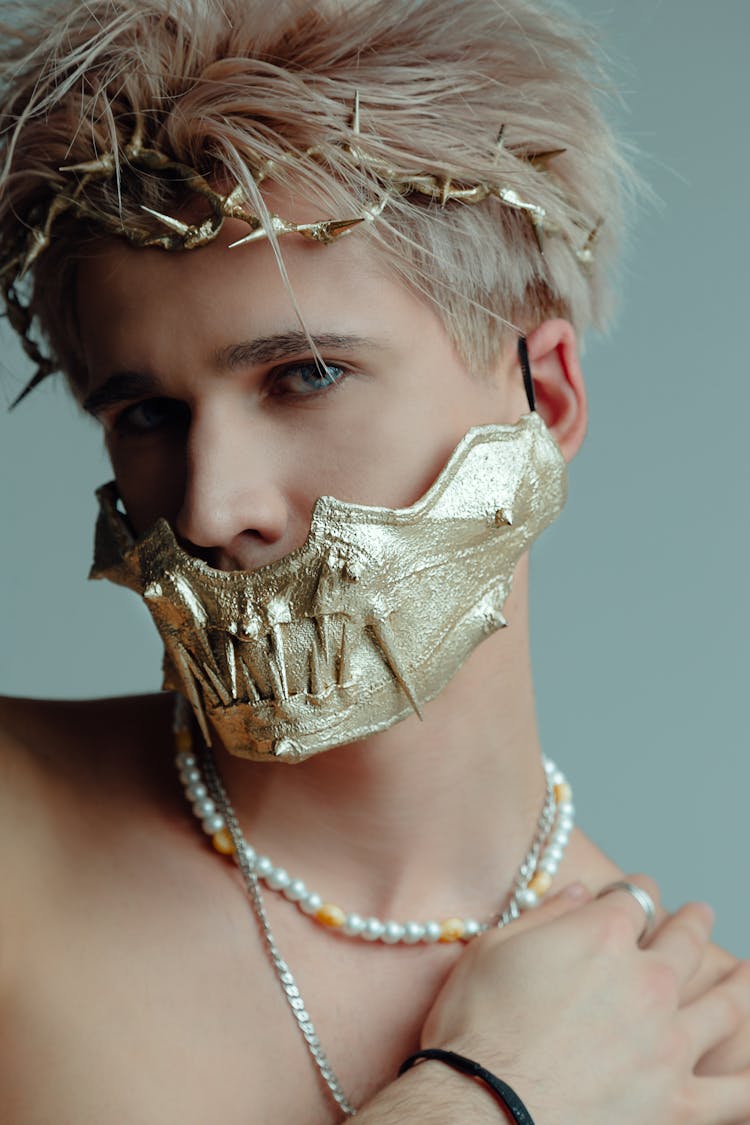 Man With Blonde Hair In A Gold Mask And A Headpiece