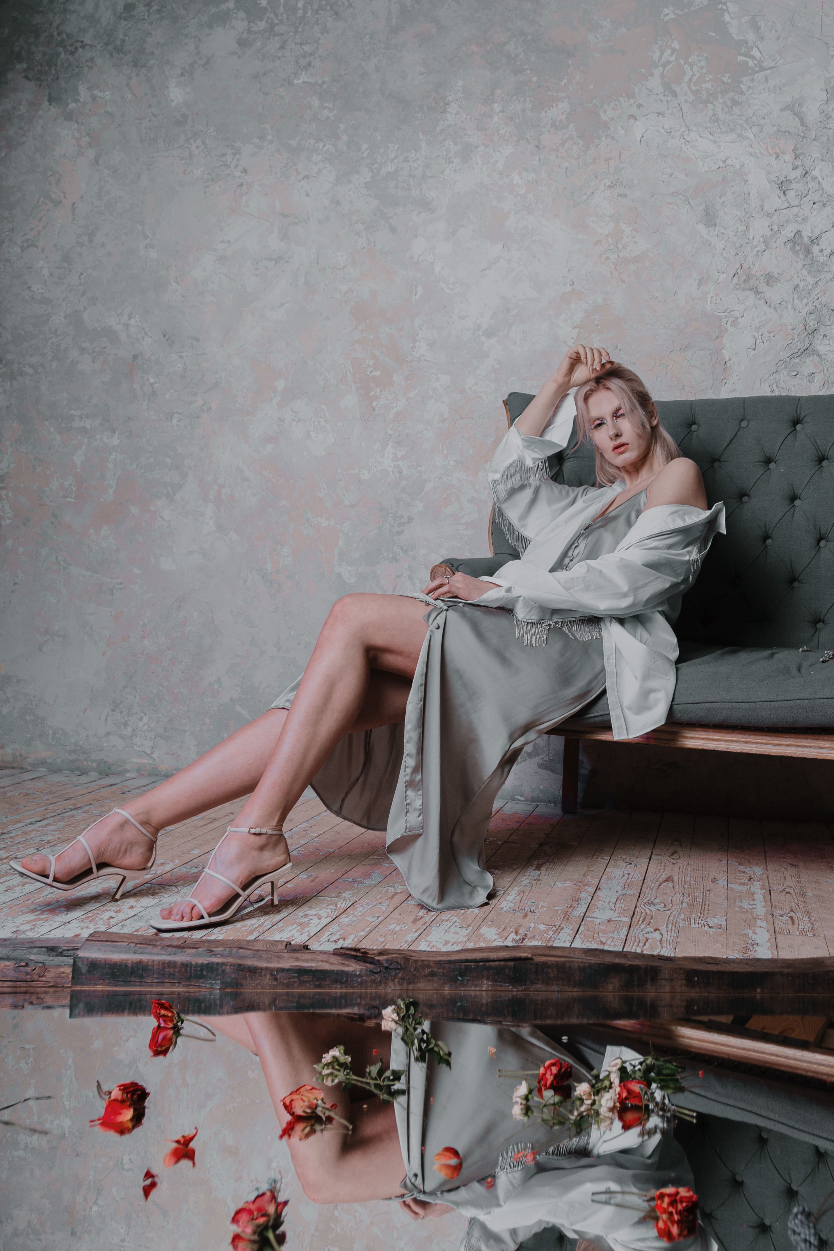 Woman in a Dress Sitting on a Sofa · Free Stock Photo