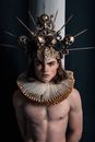 Man Wearing a Crown Made of Sculls and a Big Collar