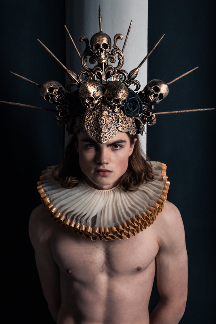 Man Wearing A Crown Made Of Sculls And A Big Collar