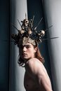 Man Wearing a Crown Made of Sculls