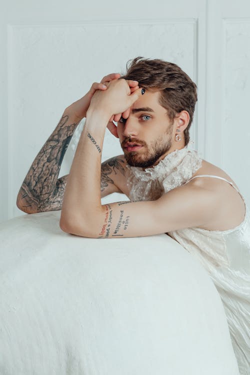 Man with Tattoos Wearing a White Lacey Dress